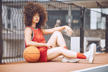 Relaxed, attitude and cool female basketball player relaxing outdoors on a court. Portrait of a...
