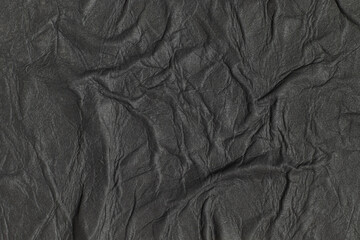 Fototapeta premium Crumpled wet black paper. Texture background.