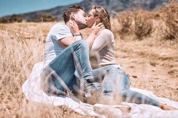 Kissing, in love and young couple on picnic valentine date outdoors in sunny summer or spring. Intimate, passionate and dating romantic cute boyfriend and girlfriend in relationship together outside. - Powered by Adobe