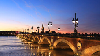 Fototapeta na wymiar Beautiful View of the Pont de pierre with sunset sky scene which The Pont de pierre crossing Garonne river.