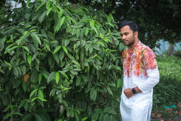 Bangladeshi young muslim boy in fashion model concept wearing traditional punjabi dress and smart watch
