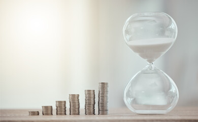 Cash coins for a future investment with hourglass, savings and growth of finance at the bank. Sand...