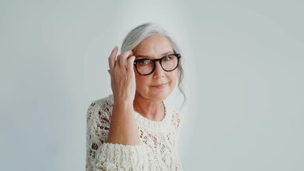 Elderly woman in casual clothes posing on a white background - Powered by Adobe