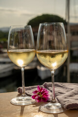 Drinking of cold white wine  with view on yacht harbour of Port Grimaud, summer vacation on French Riviera, France