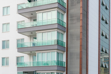 Fragment of a residential building with windows and balconies.