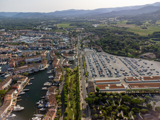 Aerial view on Gulf of Saint-Tropez, sail boats, houses of Port Grimaud and Port Cogolin, summer vacation in Provence, France
