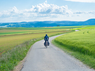 Black forest, Germany - May 29th 2022: A cyclist in the open landscape of Schwarzwald.