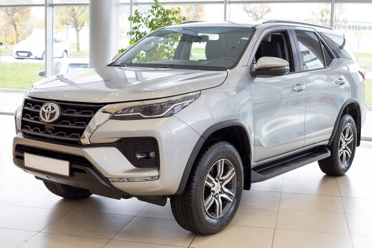 Russia, Izhevsk - September 30, 2021: Toyota showroom. New modern off-road Fortuner in dealer showroom. Front and side view. Famous world brand.