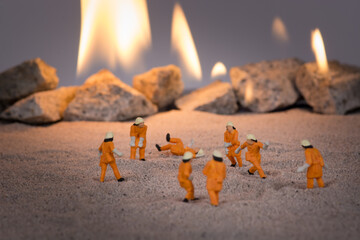 Miniature people doing a safety fire drill and one of them fake falls 