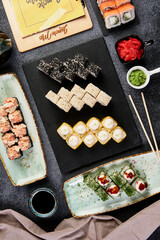 different rolls on beautiful plates with napkins top view composition