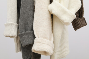 Hanging sweaters, concept of autumn season clothes