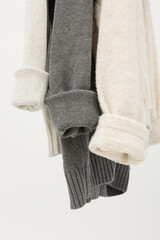 Hanging sweaters, concept of autumn season clothes