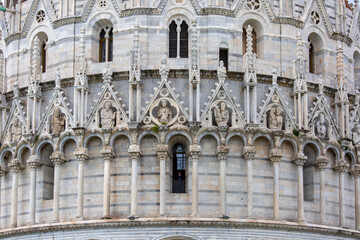 Fototapeta na wymiar Decorative facade of Pisa Baptistery of St. John on Piazza del Duomo, Pisa, Italy.