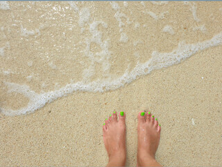 feet on the beach sand