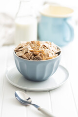 Whole grain cereal flakes. Wholegrain breakfast cereals in bowl on kitchen table.