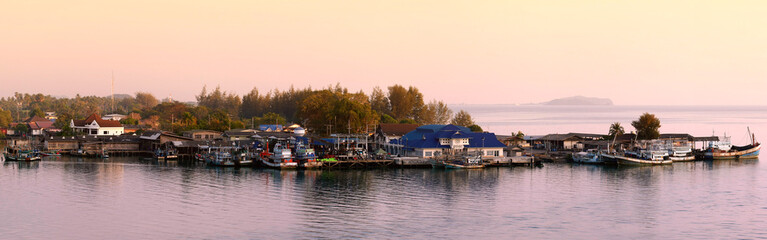 Fototapeta na wymiar Sun set over fisherman's village in Thailand.