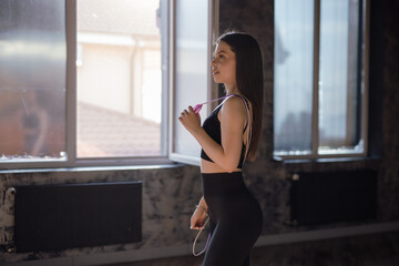 Beautiful Woman Portrait Holding Skipping Rope In The Gym