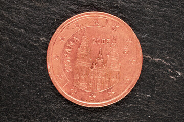One metal coin of the European Union on a slate stone, close-up, top view.