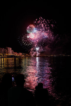  fireworks show at night on the shores of the sea of Alicante Spain