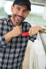 man fitting new oven in kitchen