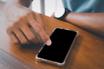 Close up hand using smartphone show black screen for your web site design, logo, app with blurred background.