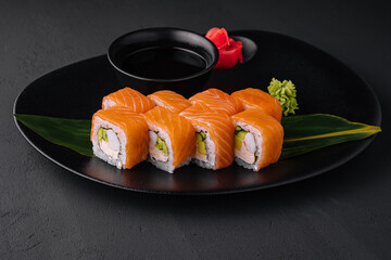 Delicious philadelphia sushi on black plate