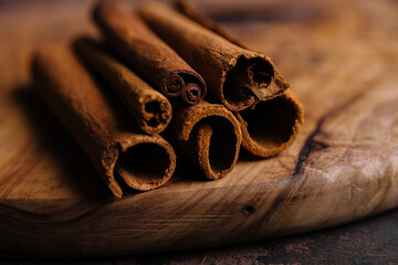 Cinnamon sticks on wooden background close-up