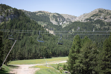 Fototapeta na wymiar Mountains landscape in summer with chairlift cables