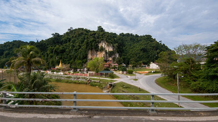 Fototapeta na wymiar Perak, Malaysia - Aug 7, 2022 : A roadside Chinese temple in the middle of Tapah town. View from the car.