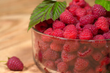 Ripe red raspberry is on the table