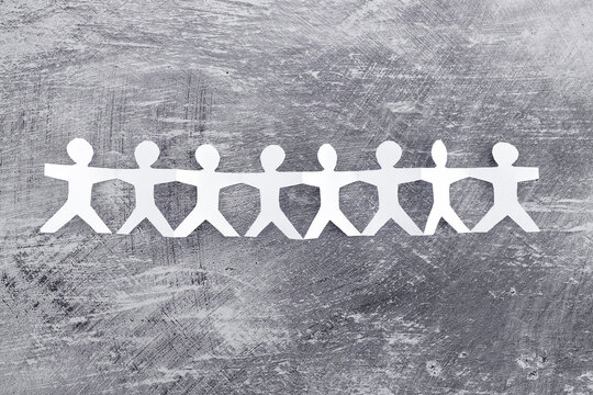 manpower and teamwork, paper people chain with text on gray background