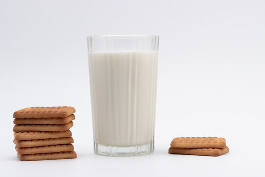 Ghaziabad, Utter Pardesh , India - August 16 2022: Parle G biscuit, A picture of parle g biscuit stacked together with a glass of milk isolated on white background
