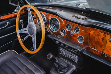 Interior of a retro sports car with steering wheel and dashboard - Powered by Adobe