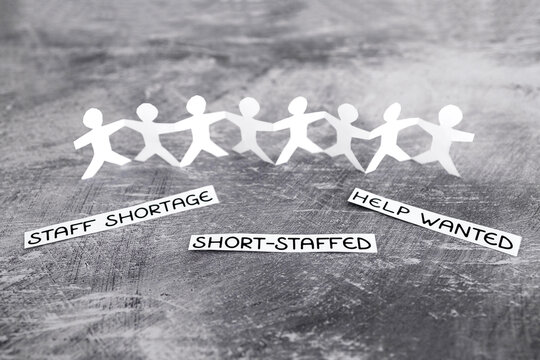 staff shortages and business struggling after the pandemic, peper people chain with text on gray background