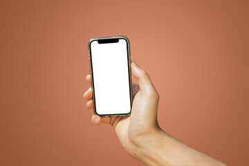 Mobile phone with empty white screen in hand on bright orange background