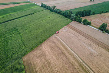 Harvester on a field in Mazowsze region, Poland, drone photo