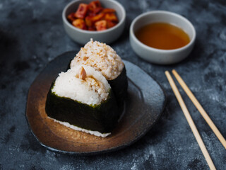 Onigiri Japanese traditional food, steamed rice in triangle shape wrap with seaweed.