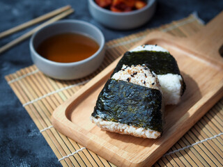 Onigiri Japanese traditional food, steamed rice in triangle shape wrap with seaweed.