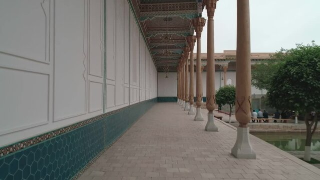 Drone cam flies between the wall and wooden carved columns