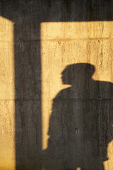 silhouette of a person standing in front of the wall
