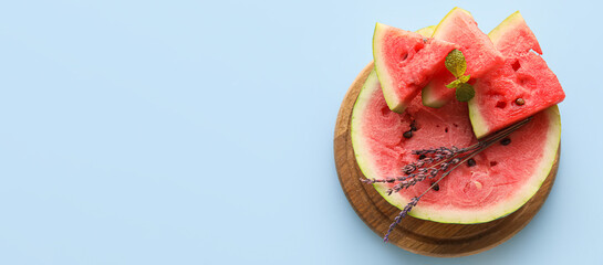 Cut sweet watermelon on light blue background with space for text