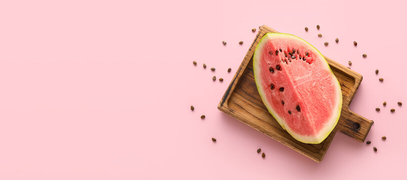 Cut sweet watermelon on pink background with space for text