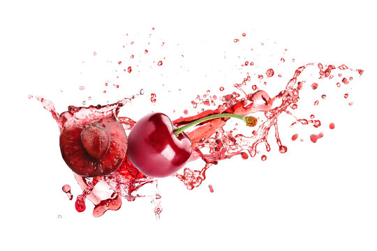 Sweet cherries and splash of juice isolated on white
