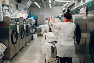 Dry cleaning with washing machine spin clothes. Clean cloth chemical process. Laundry industrial...