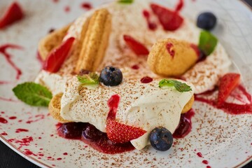 Gentle soft tiramisu. Cookies with mascarpone cream and fresh fruit.