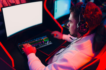 Guy playing gaming game on computer at game club.