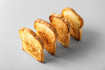 Row of tasty toasts on light background