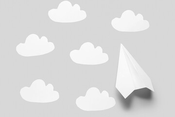 Paper plane and clouds on grey background
