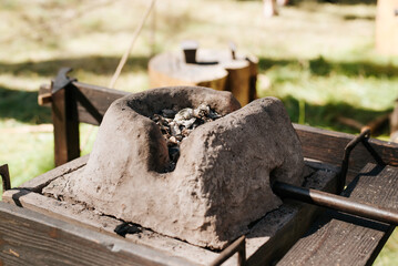 Ancient medieval forge, clay forge for forging. Close-up, selective focus