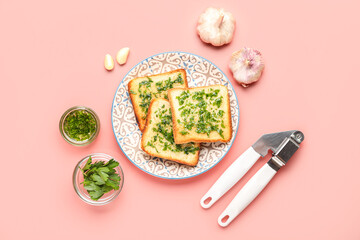 Composition with toasts of garlic bread, ingredients and press on pink background